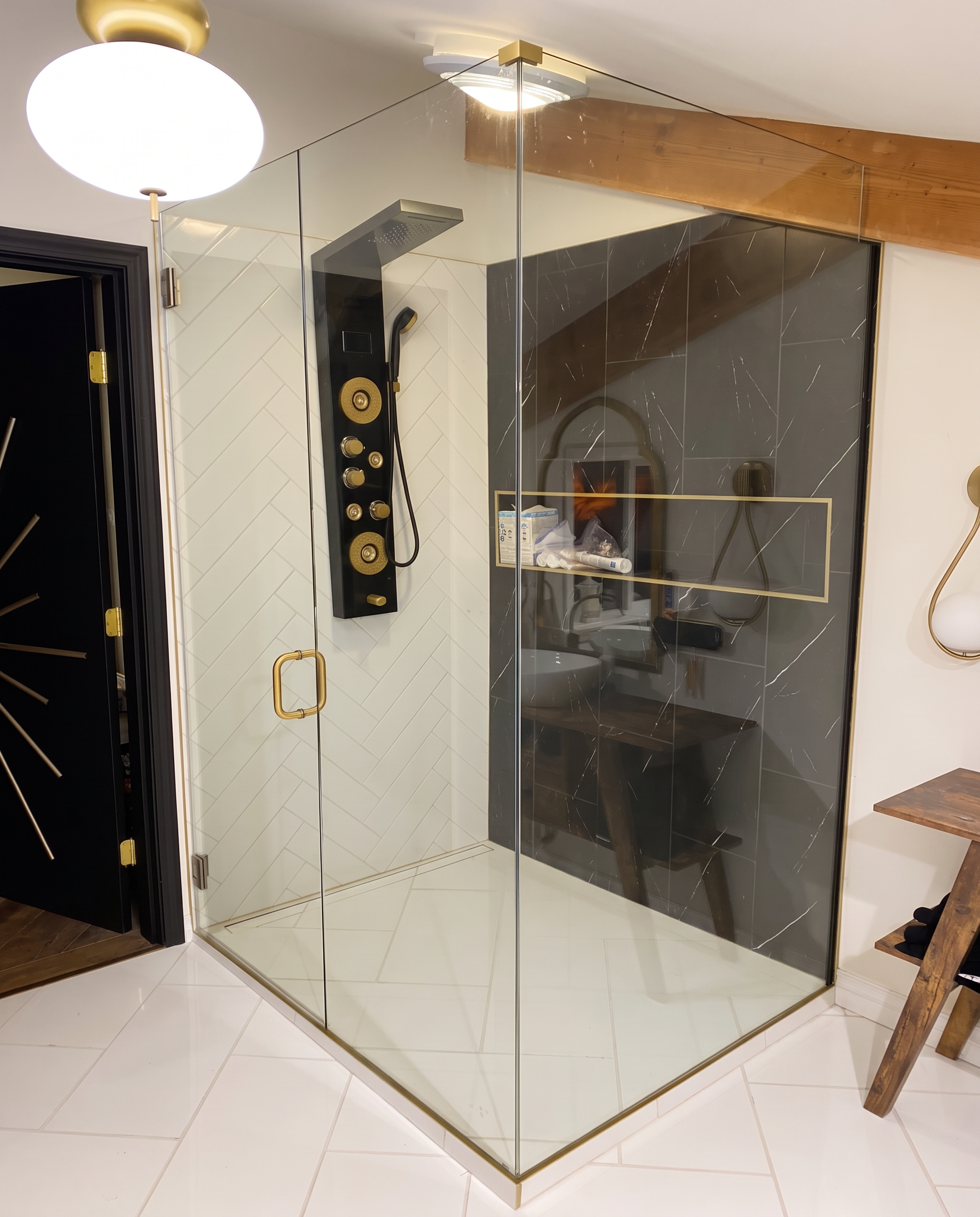 Gold-accent shower and custom bathroom tilework